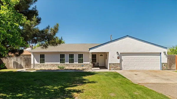 a front view of house with yard and green space