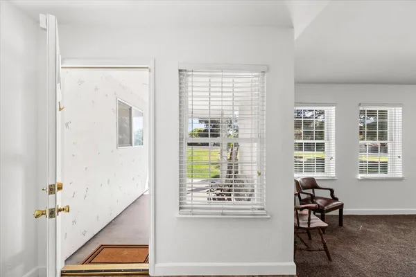 a view of an entryway with wooden floor