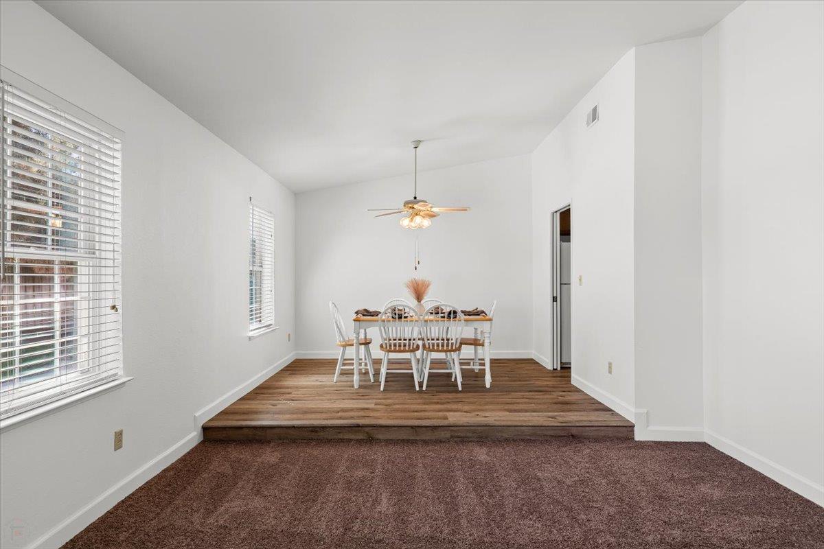 185 East Wyman Road French Camp, CA 95231 - Photo 10 of 44 a dining room with wooden floor a chandelier a wooden table and chairs