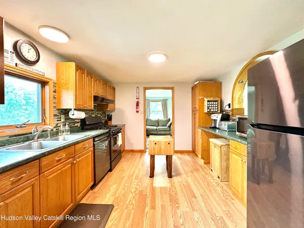 a large kitchen with a large window cabinets and stainless steel appliances