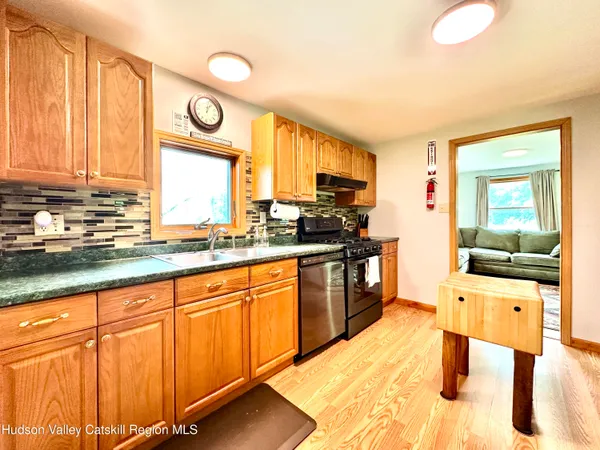 a kitchen with stainless steel appliances granite countertop a sink and cabinets