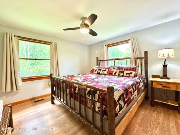 a bedroom with a bed and a large window