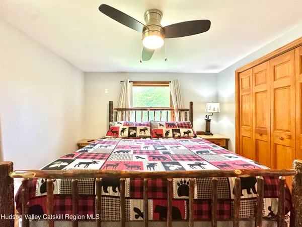 a large room with a bed and a chandelier
