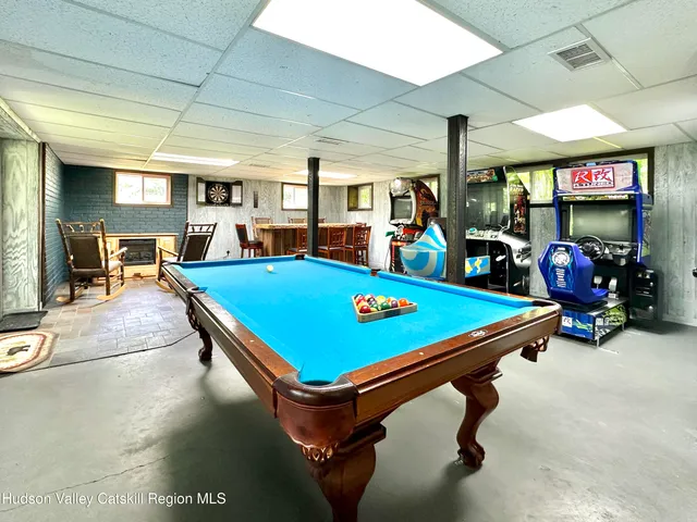 a room with pool table tennis pool table and chairs