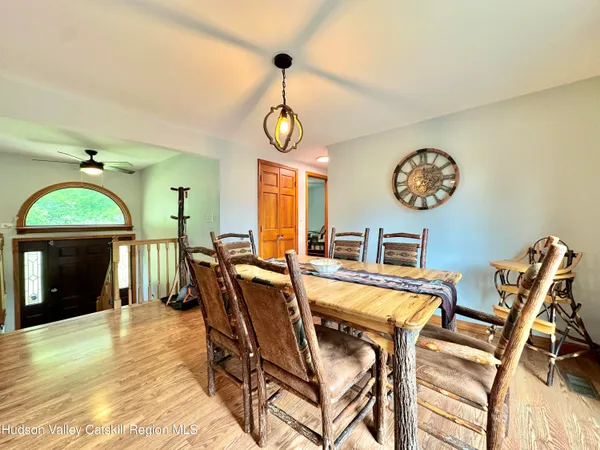 a view of a dining room with furniture and a chandelier