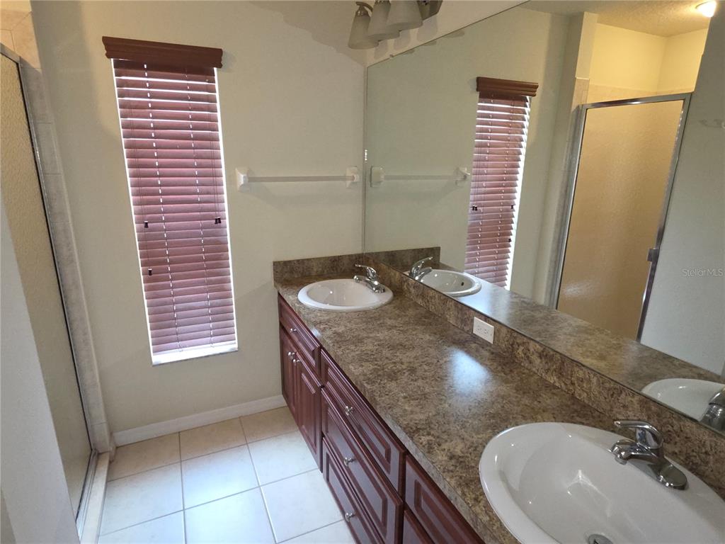 4284 High Ridge Avenue Spring Hill, FL 34609 - Photo 11 of 40 a bathroom with a sink a toilet and a mirror