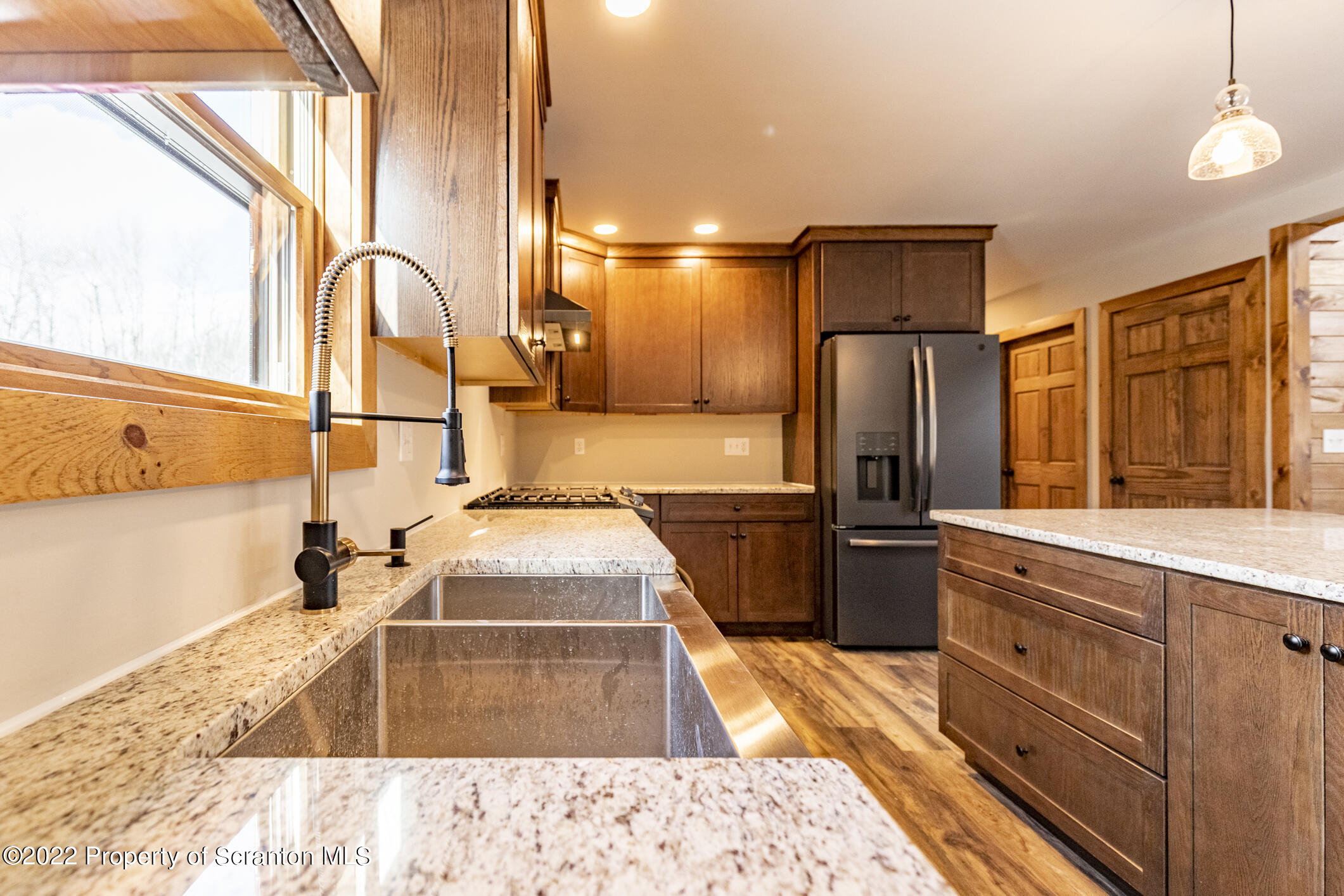 311 Jubinsky Road Waymart, PA 18472 - Photo 11 of 89 a kitchen with stainless steel appliances kitchen island granite countertop a refrigerator and a sink
