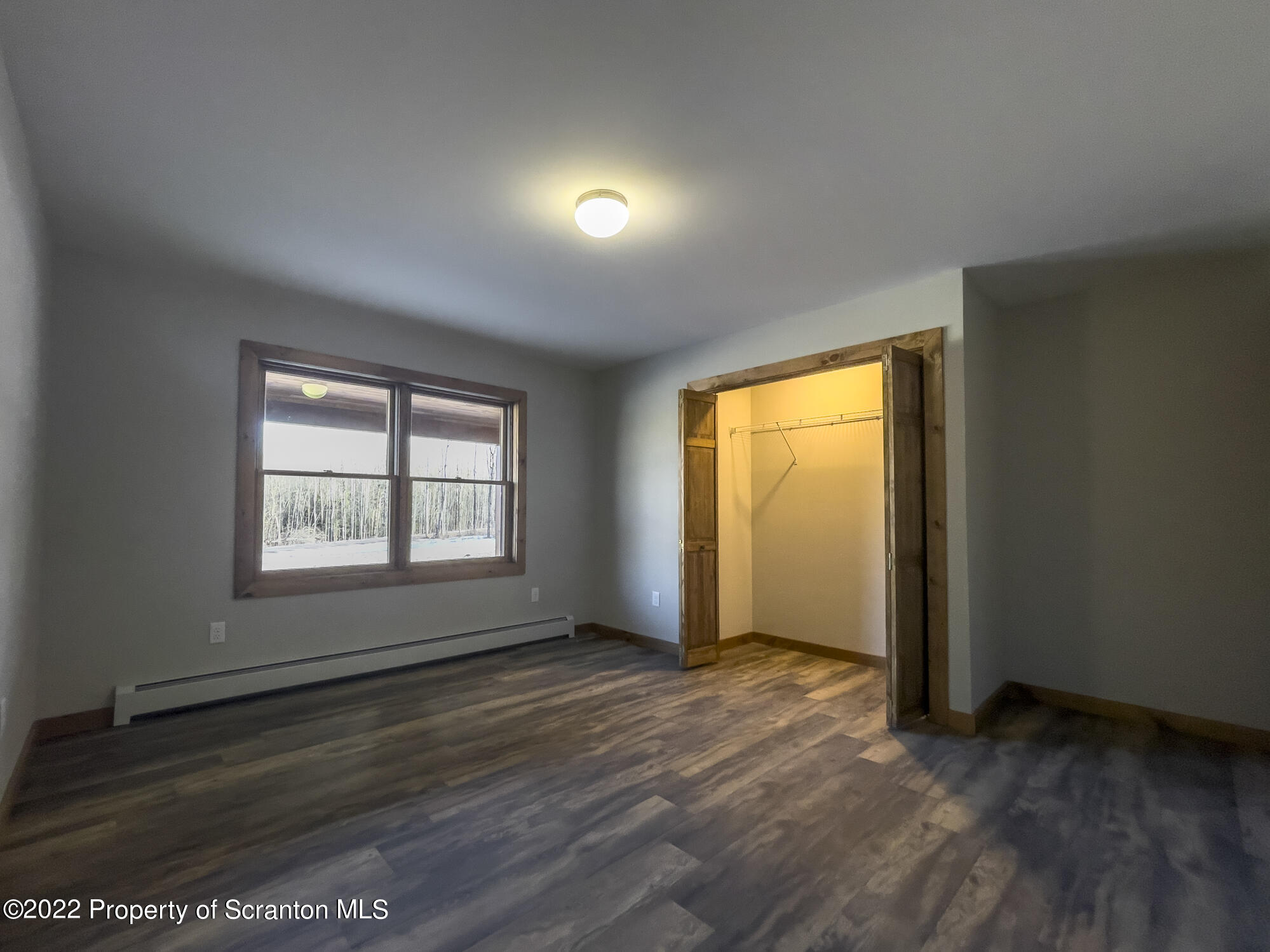 311 Jubinsky Road Waymart, PA 18472 - Photo 15 of 89 an empty room with wooden floor and windows
