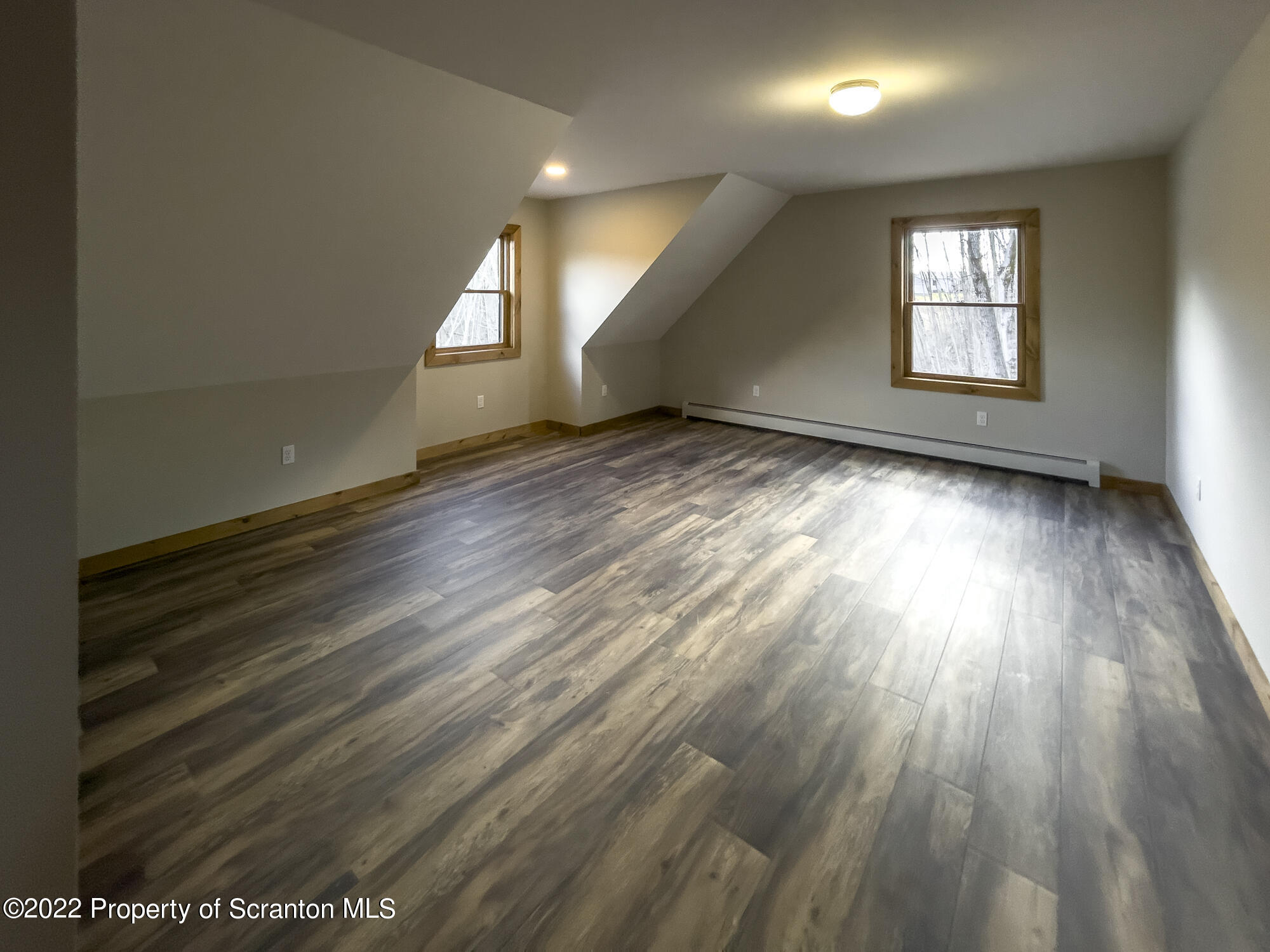 311 Jubinsky Road Waymart, PA 18472 - Photo 32 of 89 an empty room with wooden floor and windows