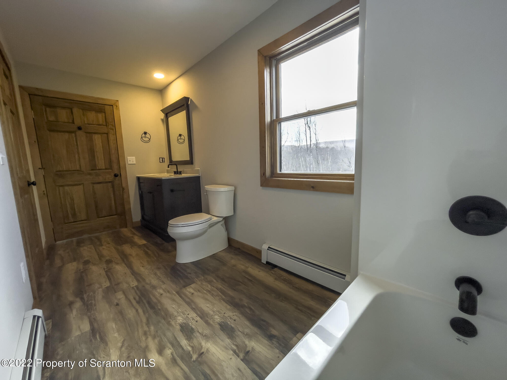 311 Jubinsky Road Waymart, PA 18472 - Photo 39 of 89 a bathroom with a toilet sink a mirror and shower