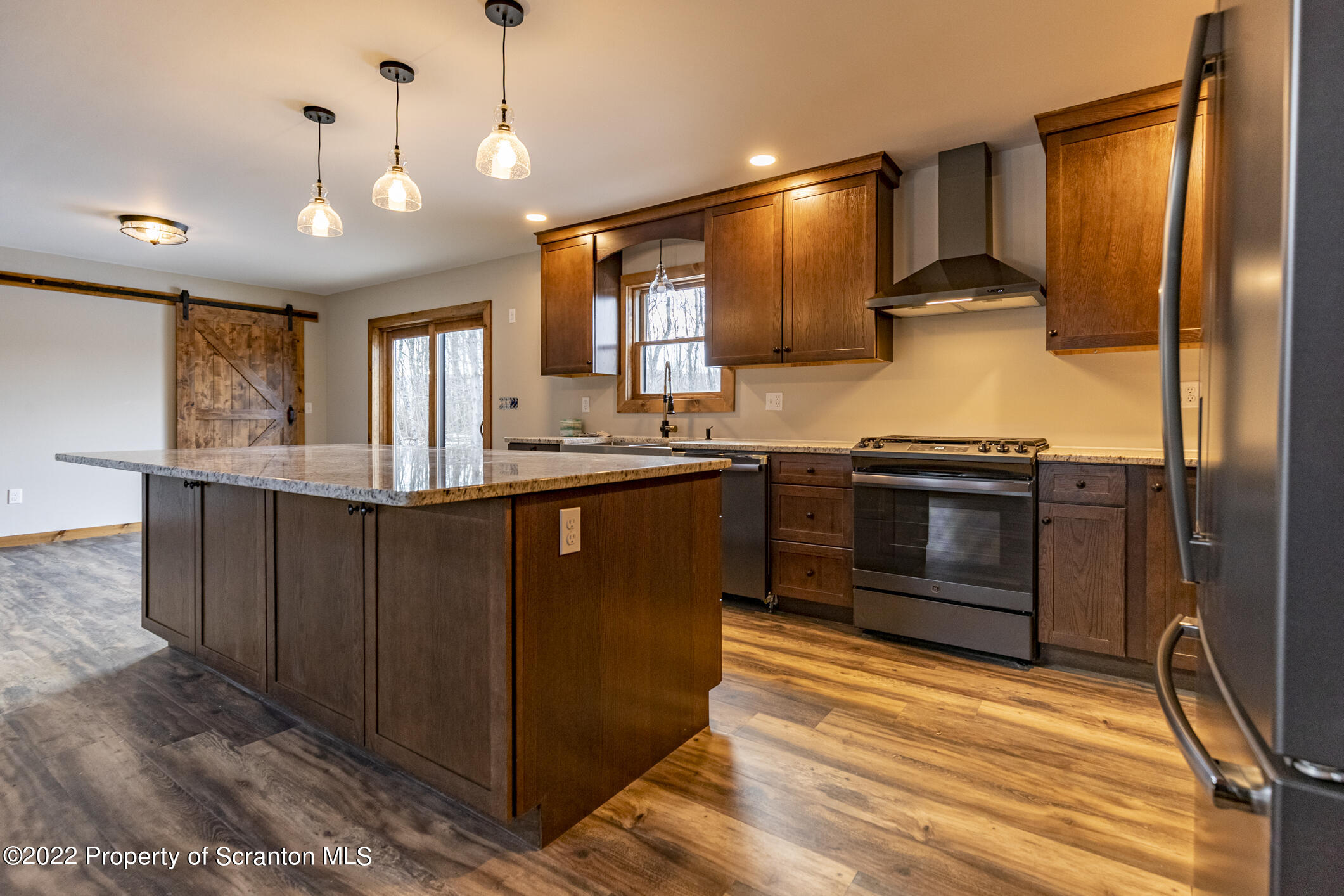 311 Jubinsky Road Waymart, PA 18472 - Photo 4 of 89 a kitchen with stainless steel appliances granite countertop a stove a sink and a refrigerator