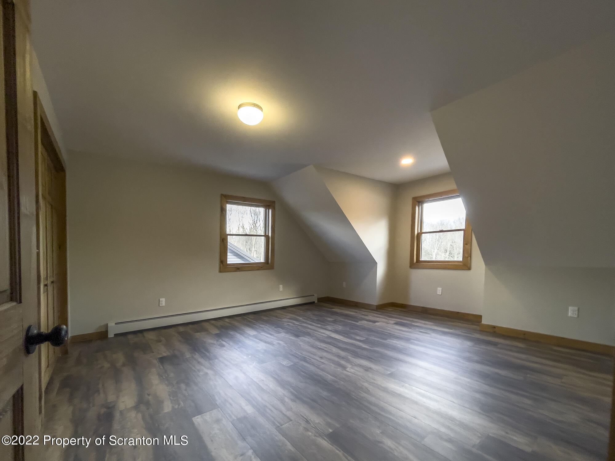 311 Jubinsky Road Waymart, PA 18472 - Photo 41 of 89 an empty room with wooden floor and windows