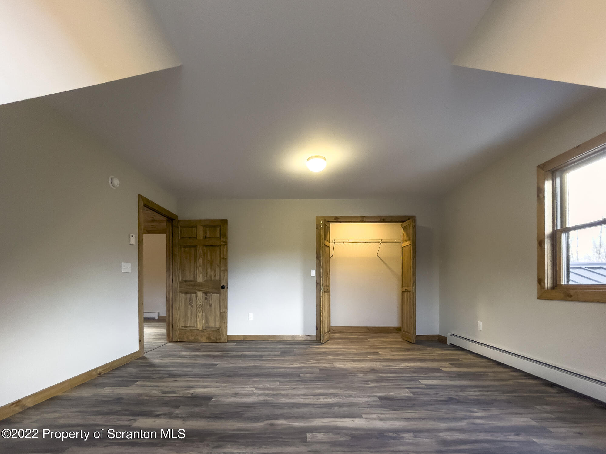 311 Jubinsky Road Waymart, PA 18472 - Photo 44 of 89 a view of an empty room with wooden floor and a window