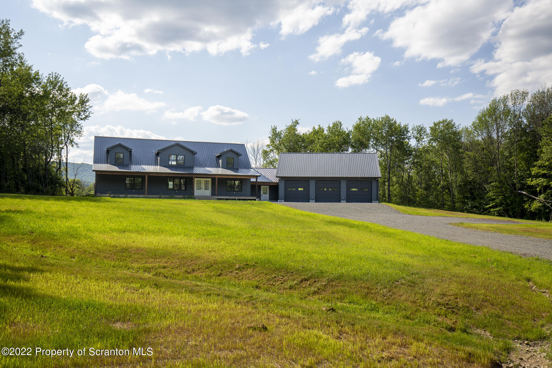 311 Jubinsky Road Waymart, PA 18472 - Photo 75 of 89 a house view with swimming pool and trees in the background