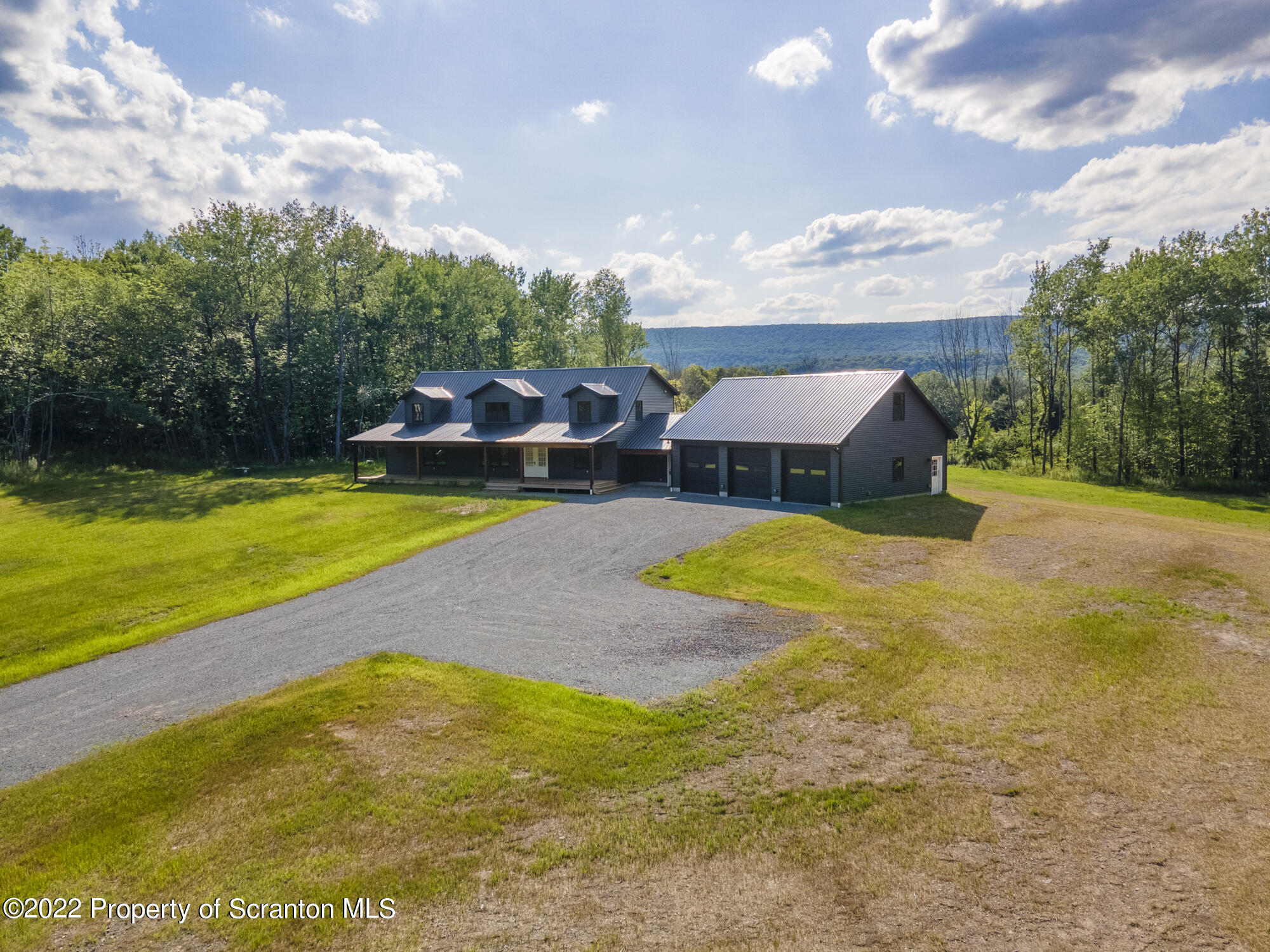 311 Jubinsky Road Waymart, PA 18472 - Photo 77 of 89 a view of swimming pool with seating area and trees in the background