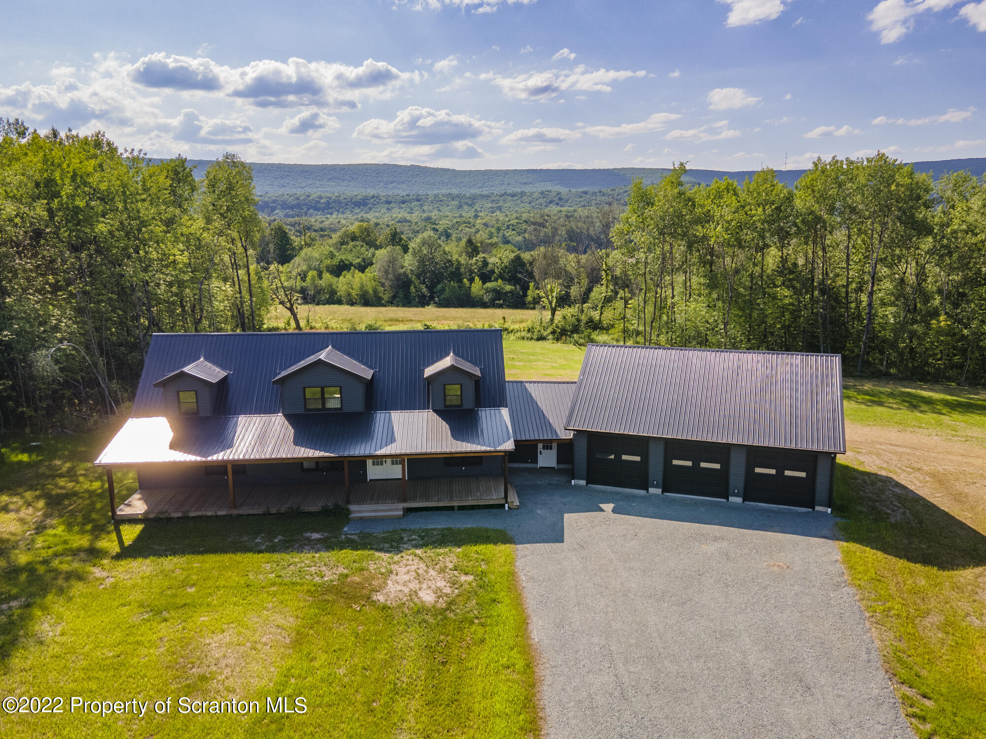 311 Jubinsky Road Waymart, PA 18472 - Photo 86 of 89 a view of a swimming pool with an outdoor seating and a garden
