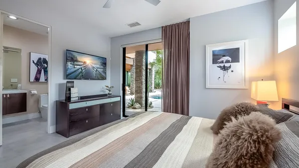 a bedroom with a bed and a flat screen tv