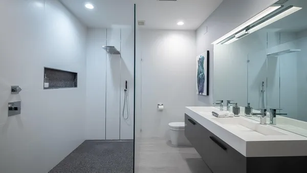 a bathroom with a double vanity sink a mirror and a shower