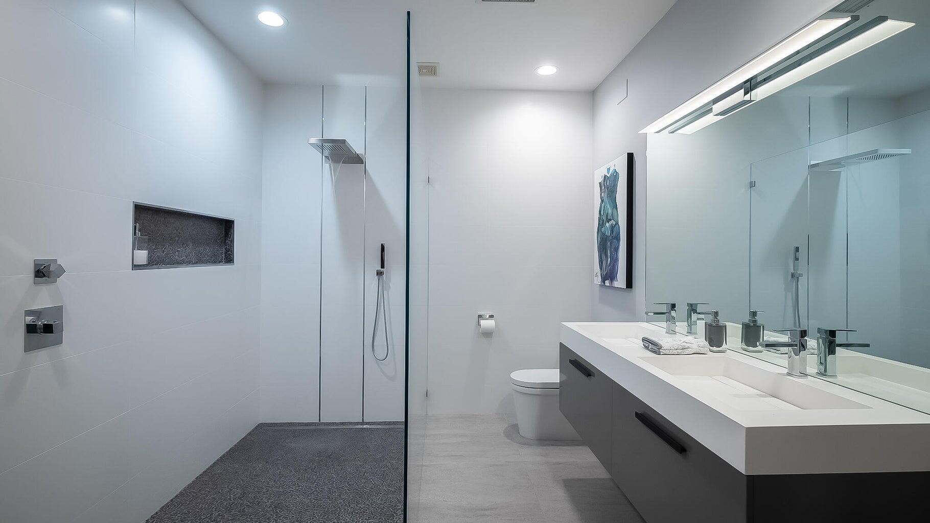 2 Dominion Court Rancho Mirage, CA 92270 - Photo 17 of 40 a bathroom with a double vanity sink a mirror and a shower