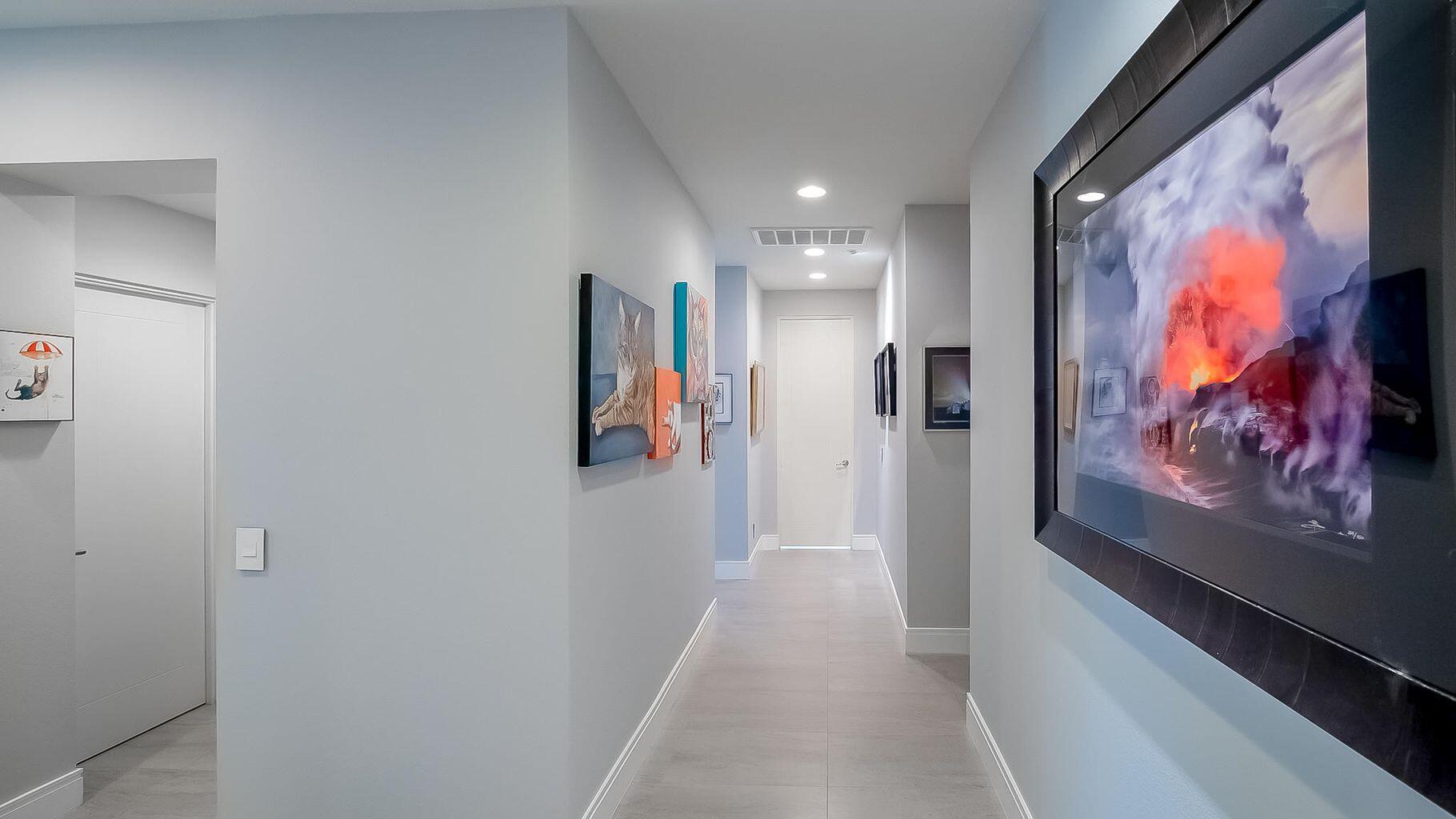 2 Dominion Court Rancho Mirage, CA 92270 - Photo 19 of 40 a view of a hallway with paintings on the wall