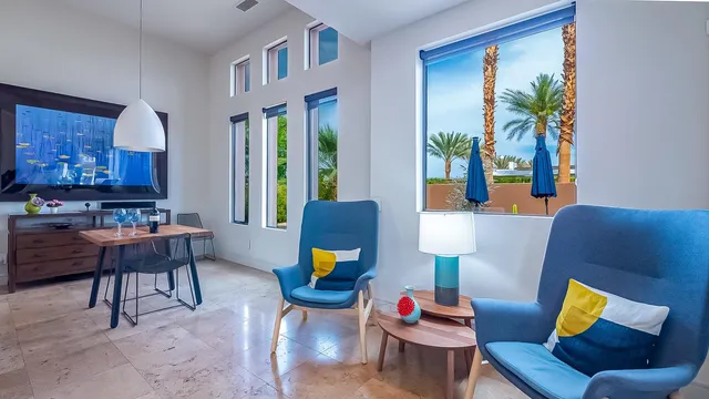 a living room with furniture and a potted plant