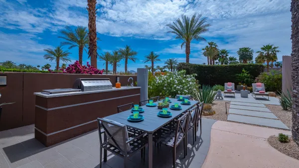 a view of a chairs and table in patio