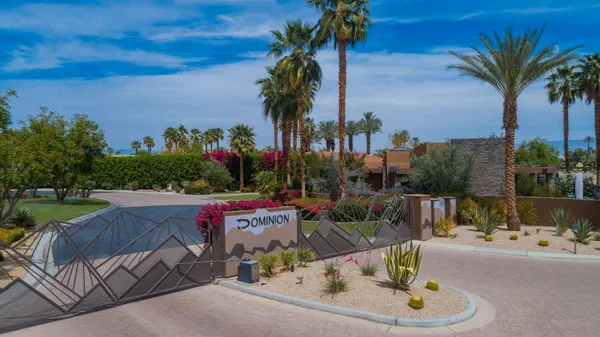 a view of backyard with swimming pool and outdoor seating