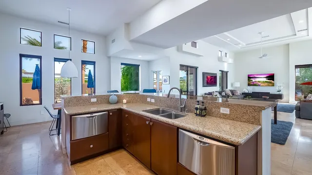 a kitchen with a sink and chairs