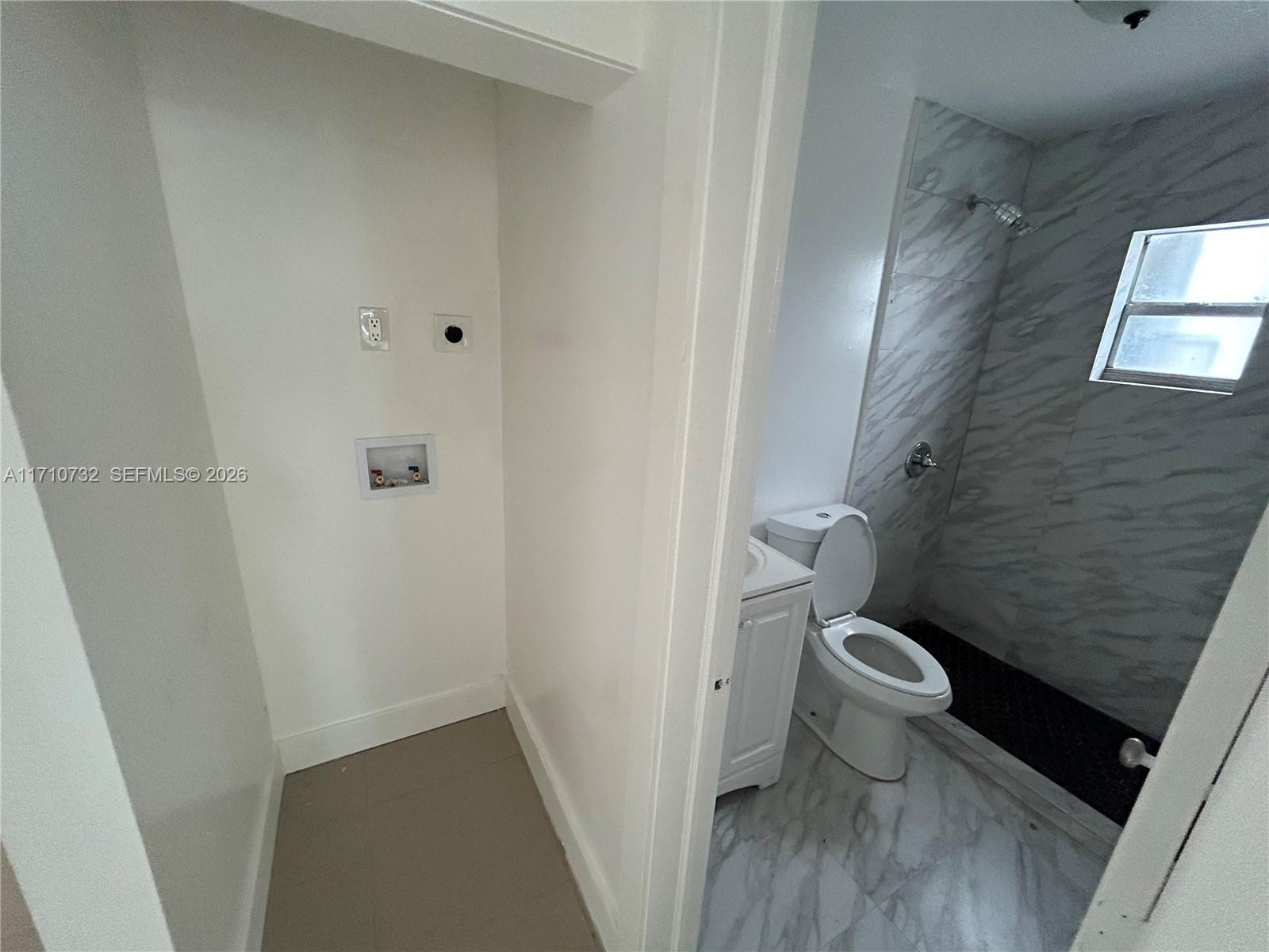 3529 Northwest 34th Street, Unit BACK Miami, FL 33142 - Photo 15 of 17 a bathroom with a toilet and a shower