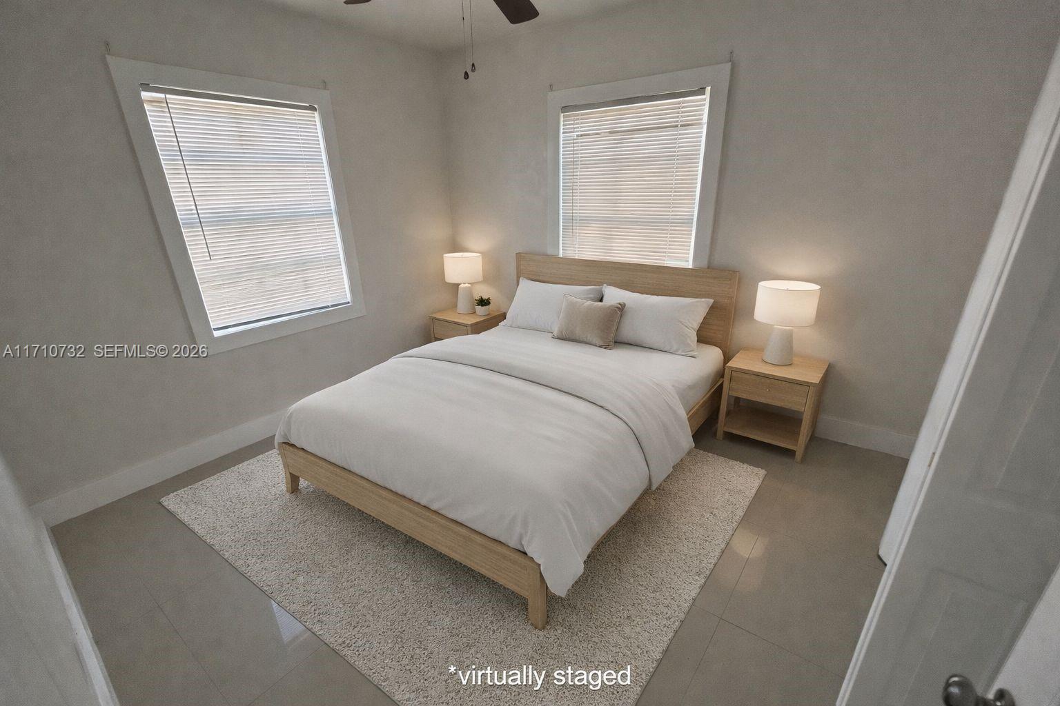 3529 Northwest 34th Street, Unit BACK Miami, FL 33142 - Photo 2 of 17 a bedroom with a bed and a window
