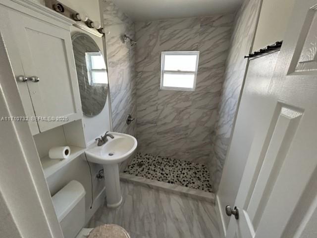 3529 Northwest 34th Street, Unit BACK Miami, FL 33142 - Photo 2 of 12 a bathroom with a sink toilet and shower