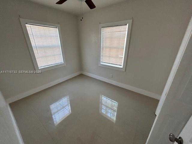 3529 Northwest 34th Street, Unit BACK Miami, FL 33142 - Photo 3 of 12 a view of an empty room with a window
