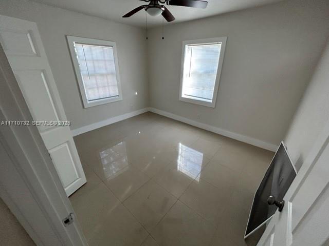 3529 Northwest 34th Street, Unit BACK Miami, FL 33142 - Photo 6 of 12 a view of an empty room with a window