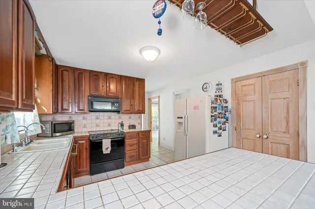 a kitchen with stainless steel appliances granite countertop a sink and cabinets