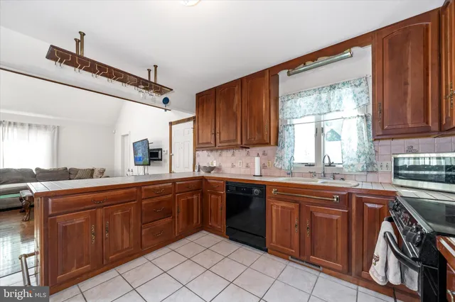 a kitchen with a sink stove top oven and cabinets