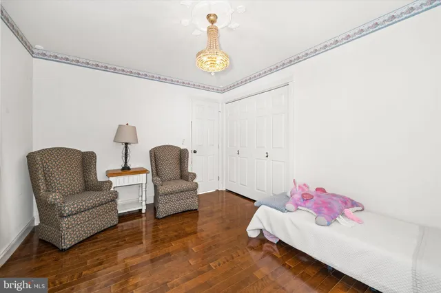 a bedroom with a bed chair and a window