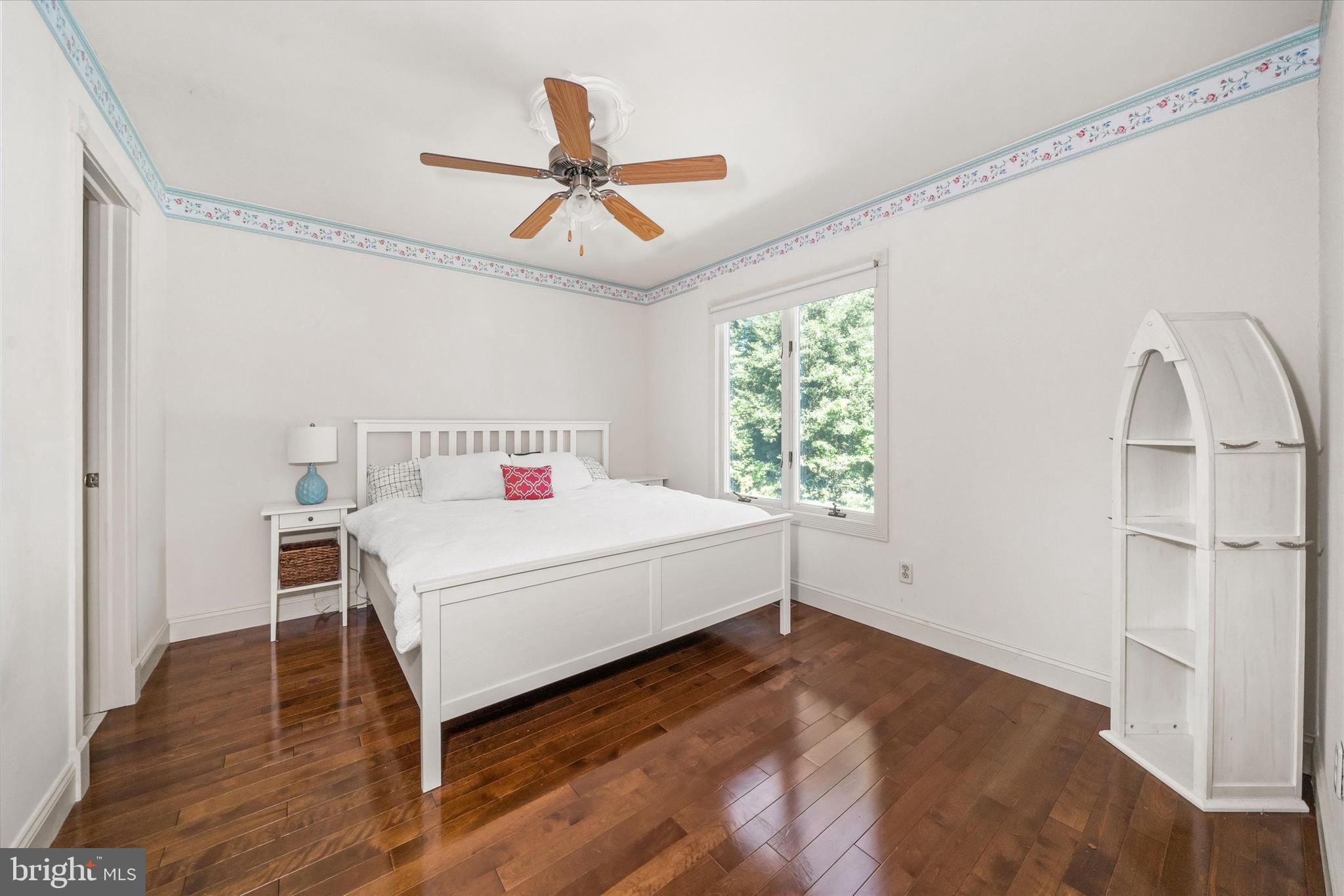 22892 Angola Road East Lewes, DE 19958 - Photo 25 of 48 a bedroom with a bed and a large window