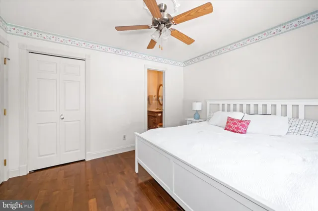 a bedroom with a large bed and a chandelier