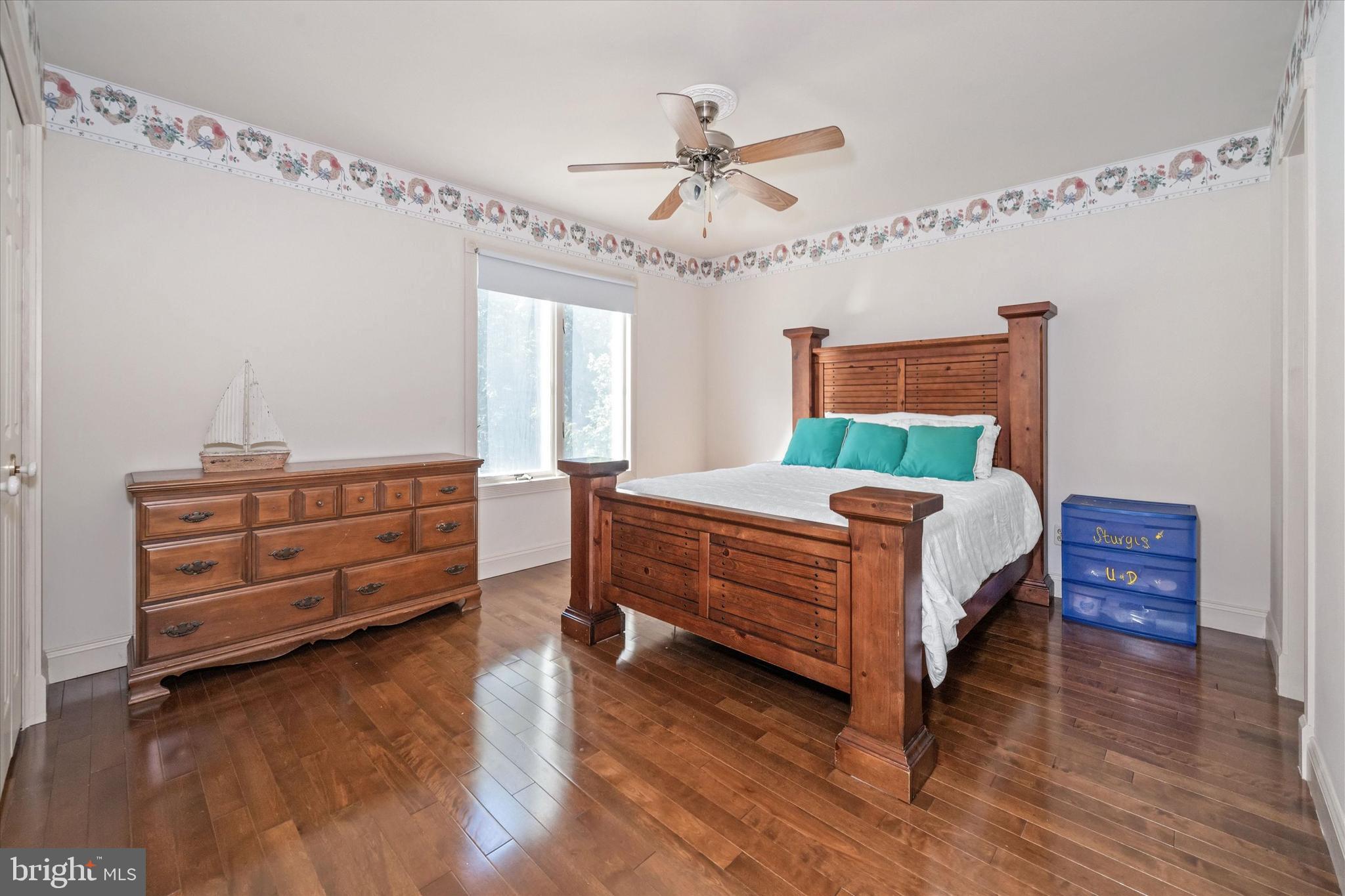 22892 Angola Road East Lewes, DE 19958 - Photo 28 of 48 a bedroom with a bed and a chandelier