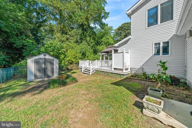 a view of a house with a yard and deck