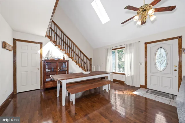 a view of entryway dining room and hall with wooden floor
