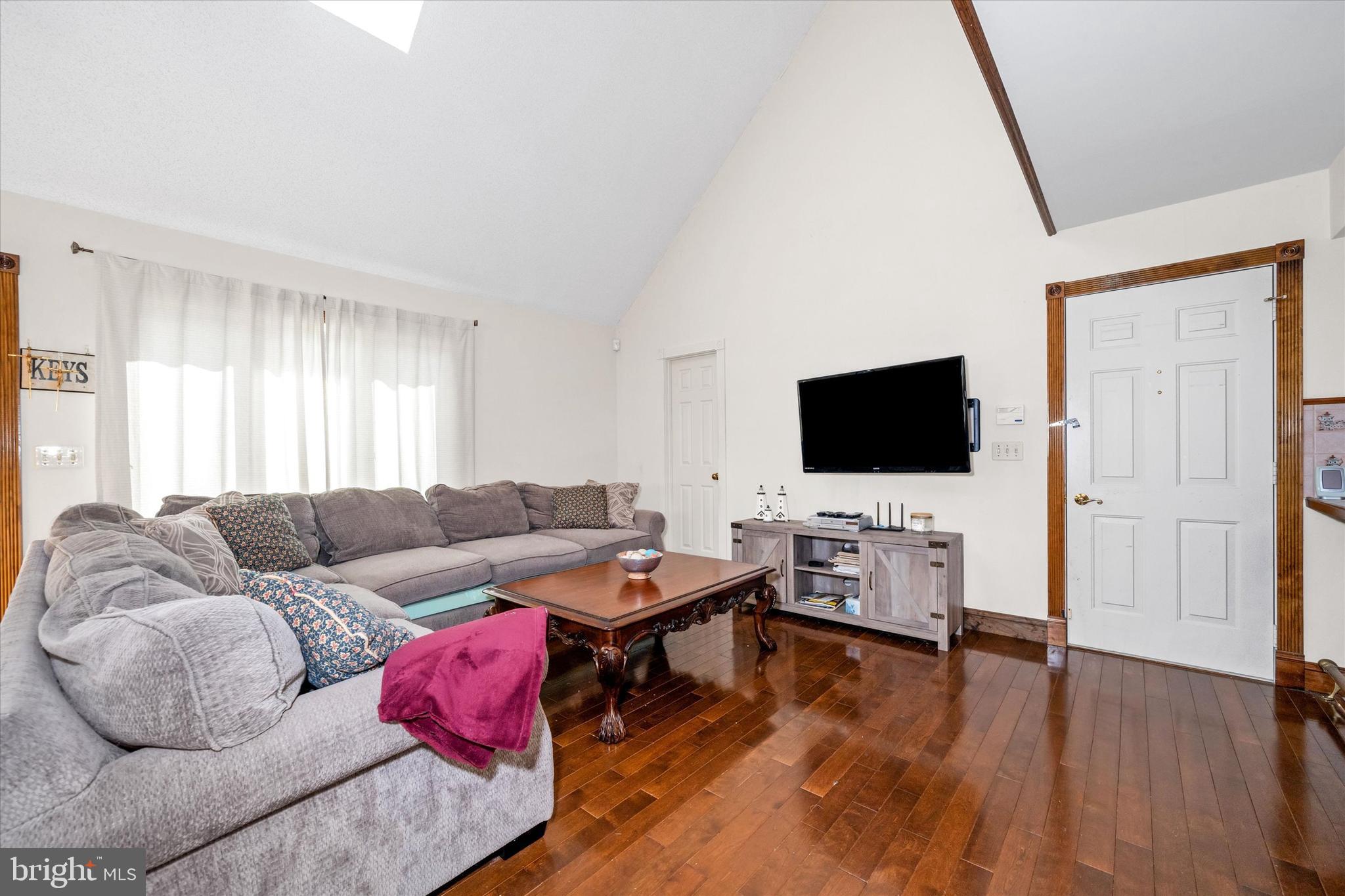 22892 Angola Road East Lewes, DE 19958 - Photo 4 of 48 a living room with furniture and a flat screen tv