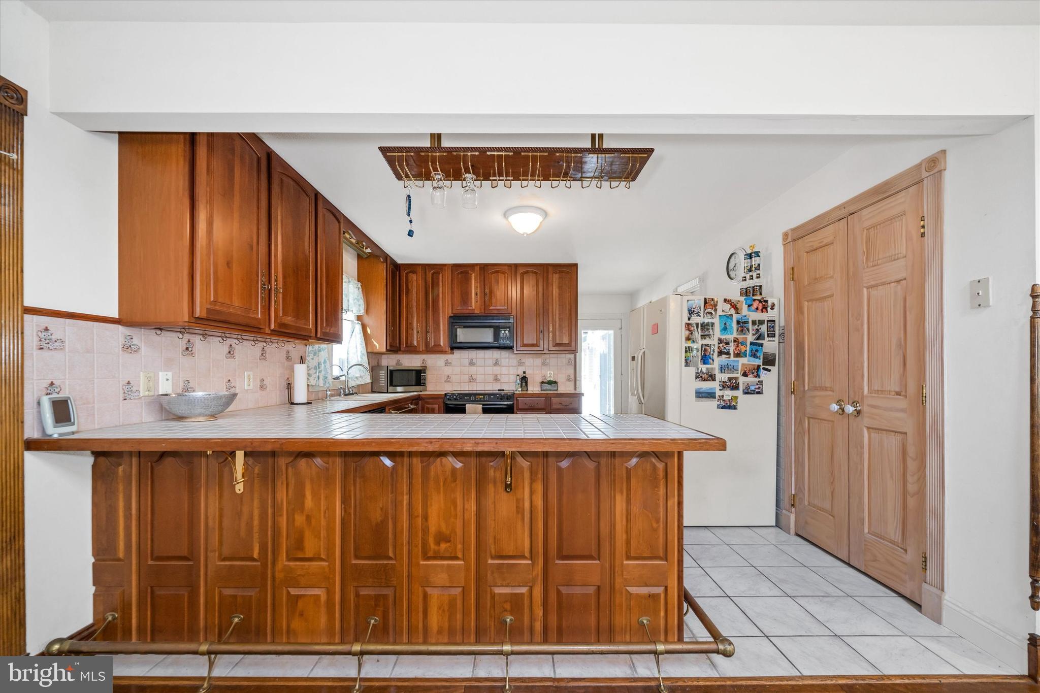 22892 Angola Road East Lewes, DE 19958 - Photo 7 of 48 a kitchen with stainless steel appliances granite countertop a refrigerator and a stove top oven