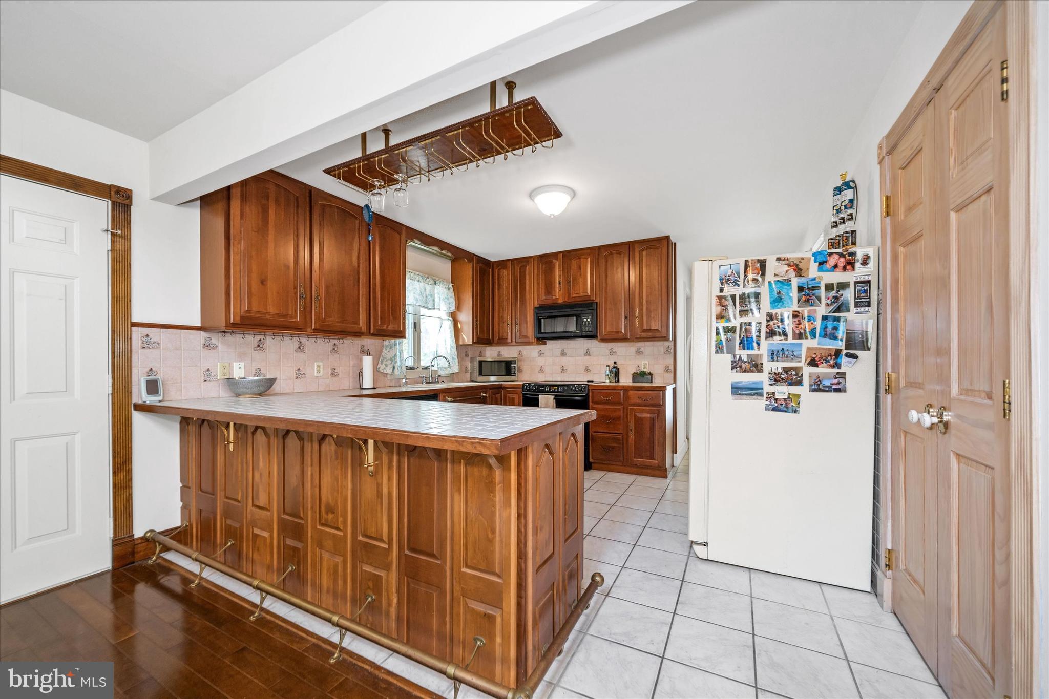 22892 Angola Road East Lewes, DE 19958 - Photo 8 of 48 a kitchen with stainless steel appliances granite countertop a refrigerator and a stove top oven