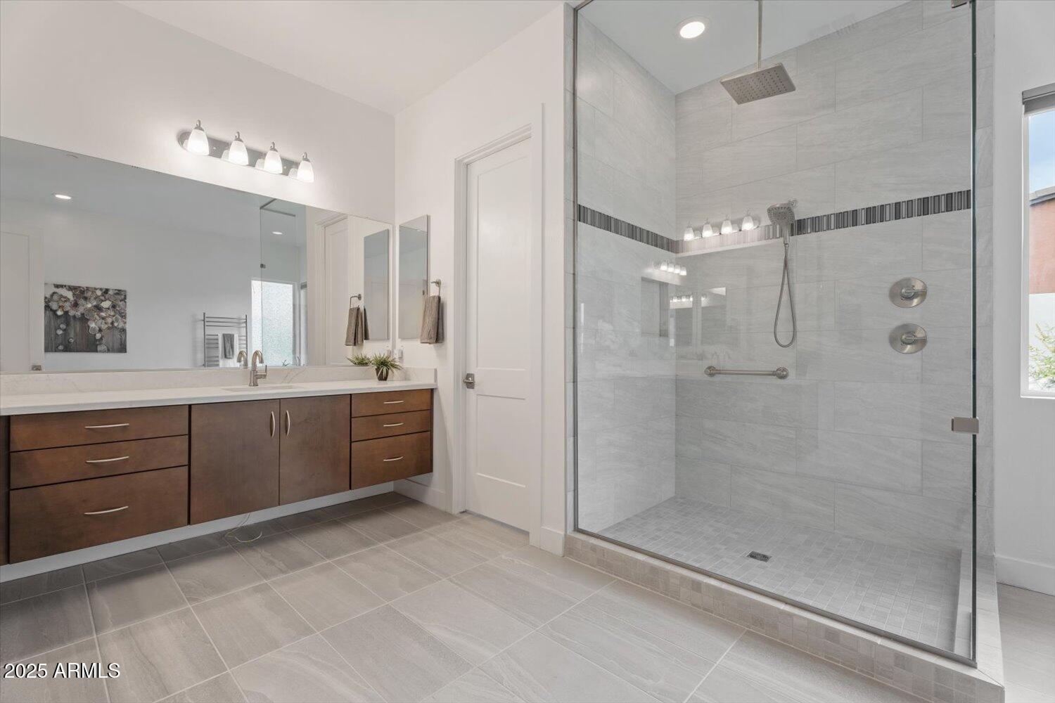 9527 South 13th Way Phoenix, AZ 85042 - Photo 14 of 44 a bathroom with a shower a sink mirror and double