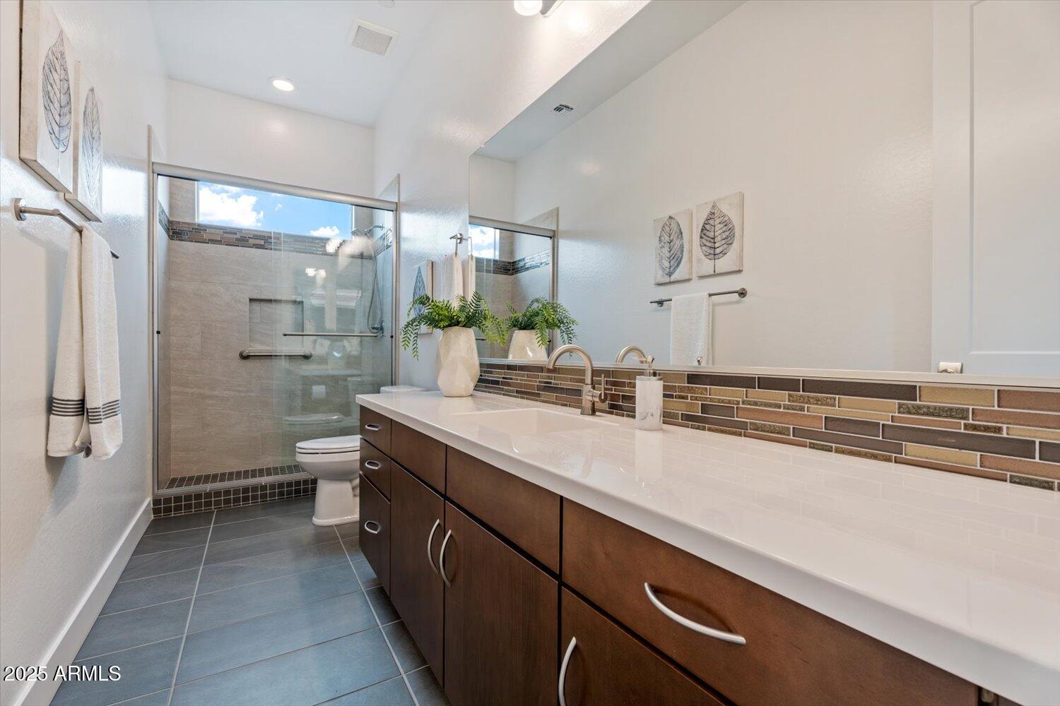 9527 South 13th Way Phoenix, AZ 85042 - Photo 20 of 44 a spacious bathroom with a granite countertop sink a toilet and shower
