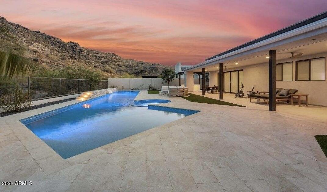 9527 South 13th Way Phoenix, AZ 85042 - Photo 25 of 44 a view of swimming pool with seating area and mountain view in back