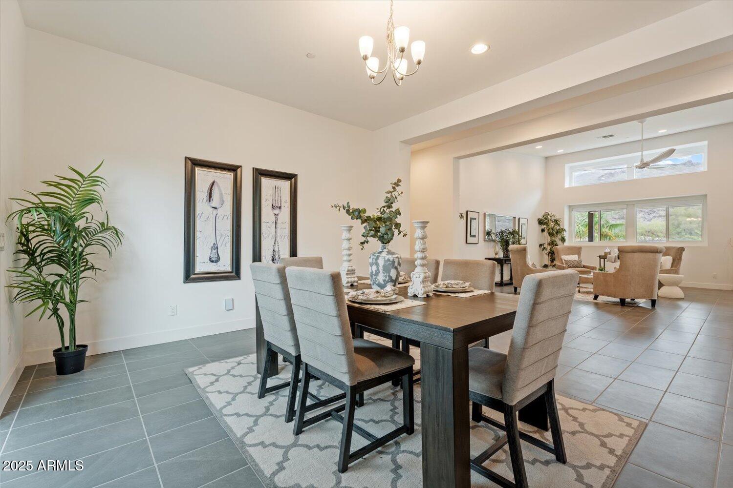 9527 South 13th Way Phoenix, AZ 85042 - Photo 6 of 44 a view of a dining room with furniture and a chandelier