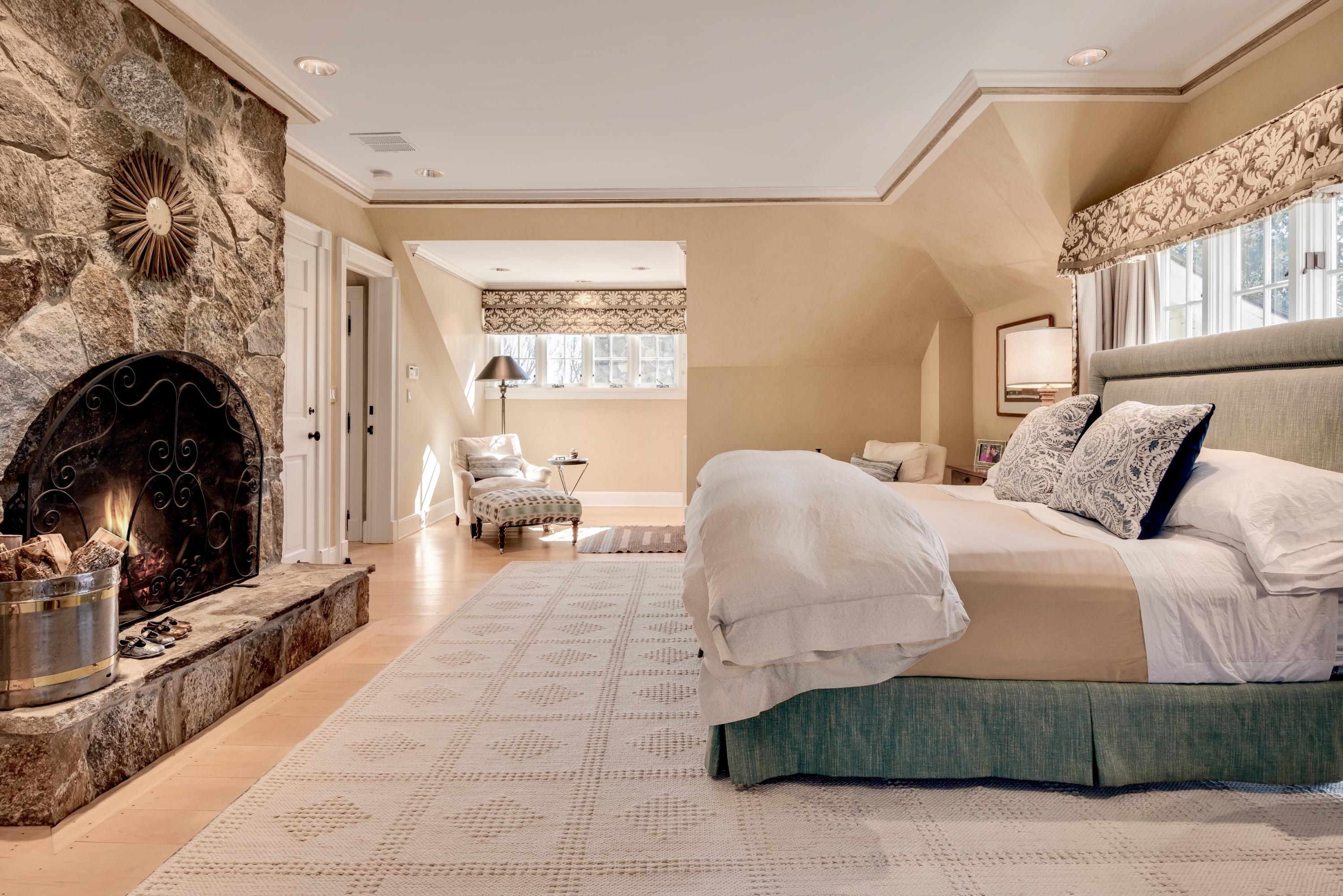 265 Brushy Ridge Road New Canaan, CT 06840 - Photo 22 of 39 a bedroom with a bed a flat screen tv and a fireplace