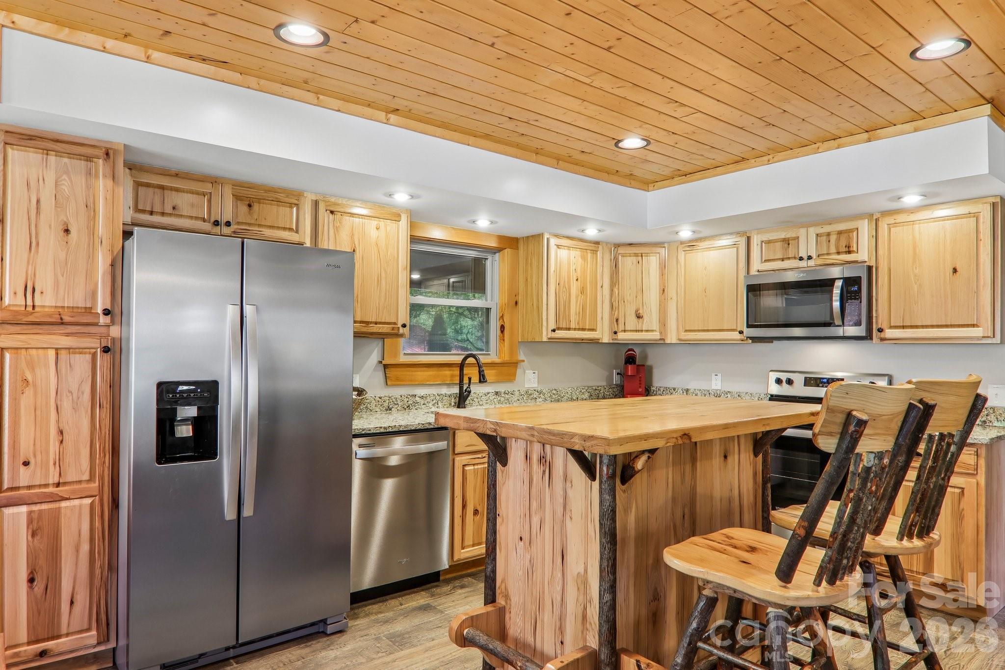 589 Panoramic Loop Maggie Valley, NC 28751 - Photo 13 of 47 a kitchen that has a lot of cabinets a sink and appliances
